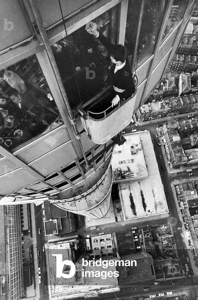Window cleaner Adrian Rogers in his cradle as he cleans one of the many windows at the GPO Tower in London.
7th June 1966.