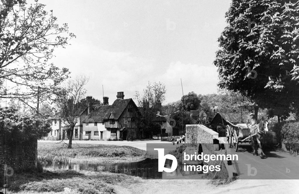 Horse-drawn cart crossing the bridge over the ford at Eynesham, Black Country, 1935 (b/w photo)
