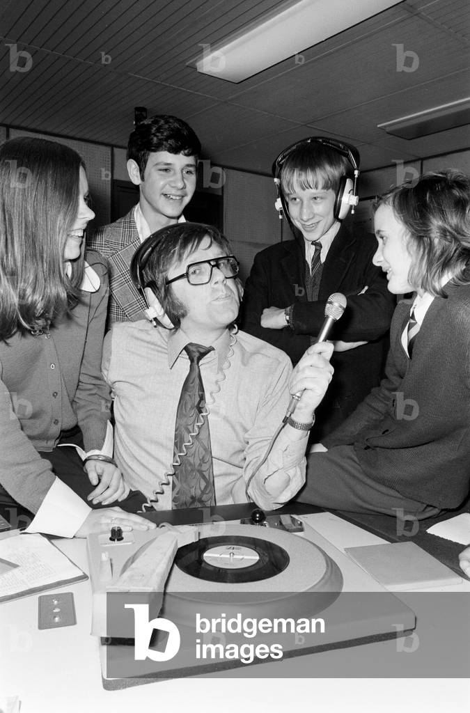Ed Doolan BRMB Radio Disc Jockey, pictured with news boys and girls, Birmingham, 14th January 1975 (b/w photo)