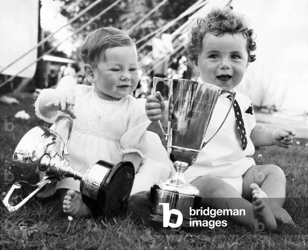 Mandy Turnbull (left) and Roger O'Brien proudly display the trophies which prove their title to be the bonniest baby girl and boy at the Tyneside Summer Exhibition. Exhibition Park, Newcastle. 6th August 1969.