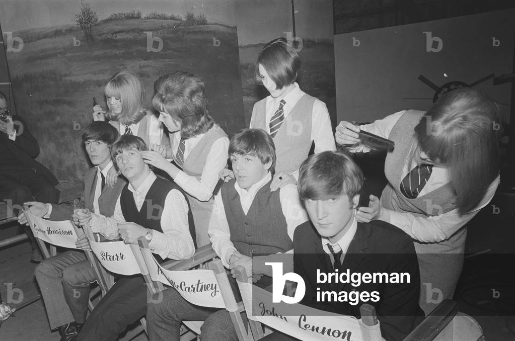 The Beatles pose for pictures during filming of A Hard Day's Night at Madame Tussauds in London 12th March 1964.