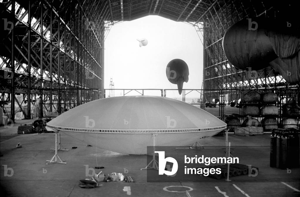 A flying saucer was seen at Cardington formerly the Royal Airship Works, Beds. with a thirty ft. diameter the Prototype of what will be the World's biggest flying machine is being built in the R100 Airship hanger, April 1975 (b/w photo)