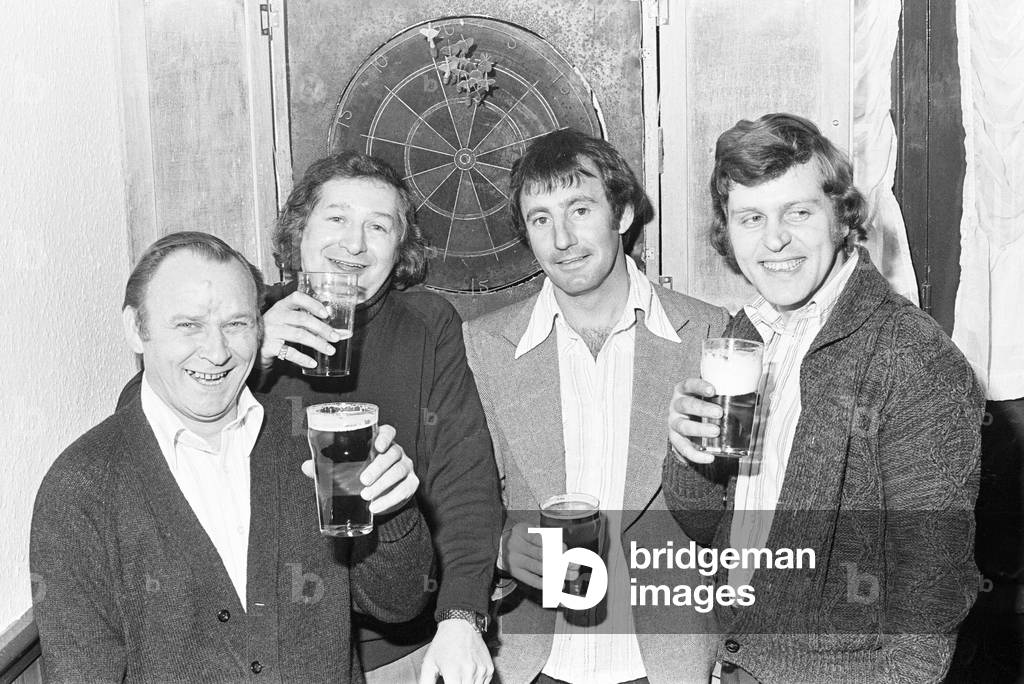Regular customers at the New Cresta club in Solihull, West Midlands, enjoying a pint during a game of darts. 
25th March 1977.