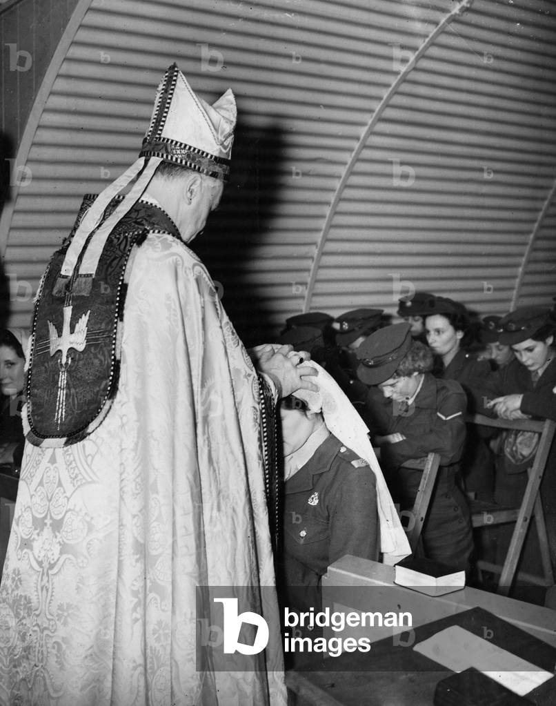 Religion Confirmation
In a small nissen hut at ATS D Camp Dennington the Bishop of Shrewsbury in cape and mitre confirms 7 ATS privates 
November 1946