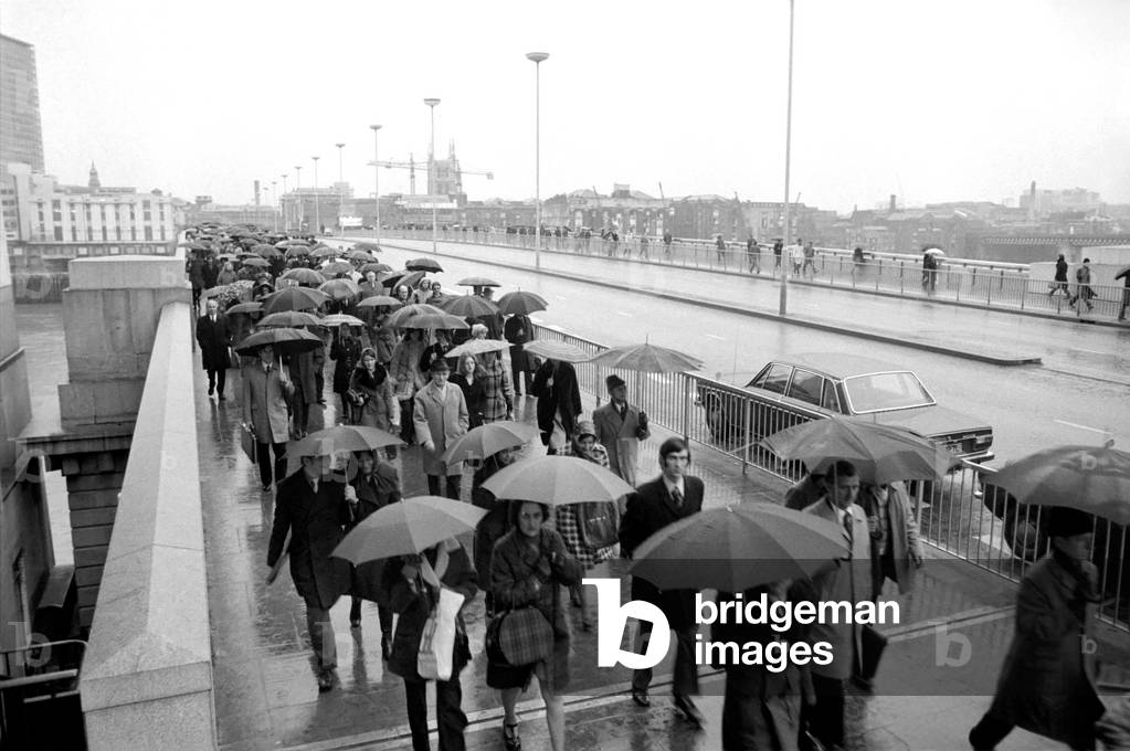 People walking to work, January 1975 (b/w photo)