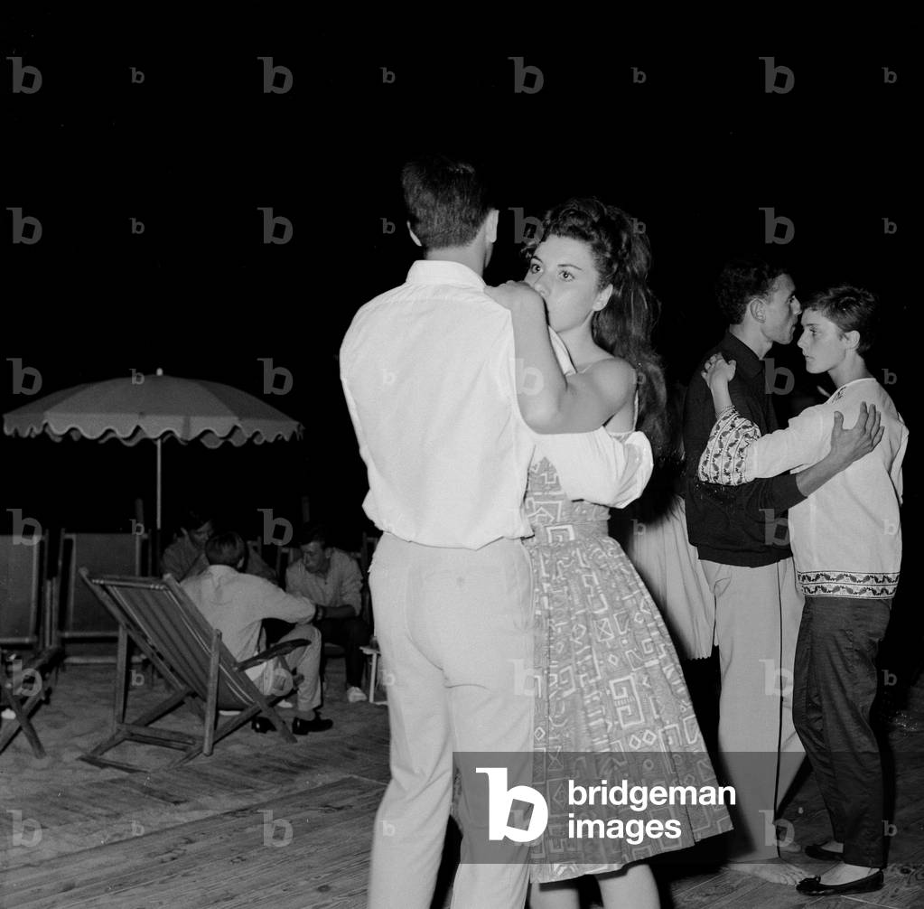 Couples slow dancing on the dancefloor of a bar in the French Riviera. 2nd August 1961 (b/w photo)