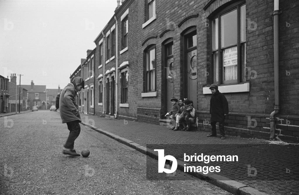 Two boys playing football, Marshall Street, Smethwick, Black Country, 1964 (b/w photo)