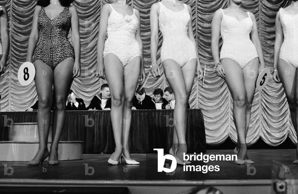 Participants in the Miss Margate National Bathing Beauty Contest stand in front of the judges during the competition held at Margate's Winter Gardens. The judges were six sailors from HMS Kent, Margate's adopted ship. 22nd July 1966 (b/w photo)