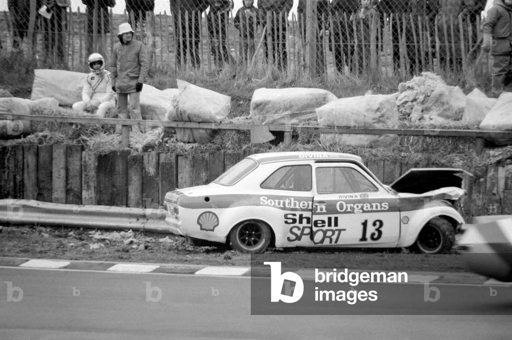 Britain's ex-ski champion Divina Galicia crashed her £6000 car on the second lap of her very first professional race at Brands Hatch today, 2nd February 1975 (b/w photo)