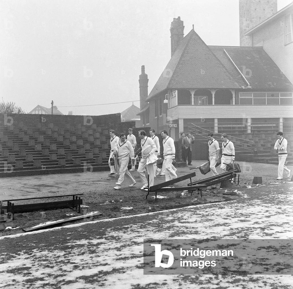 Yorkshire County Cricket Club, players head to the practice shed with snow still on the ground, 5th April 1961 (b/w photo)