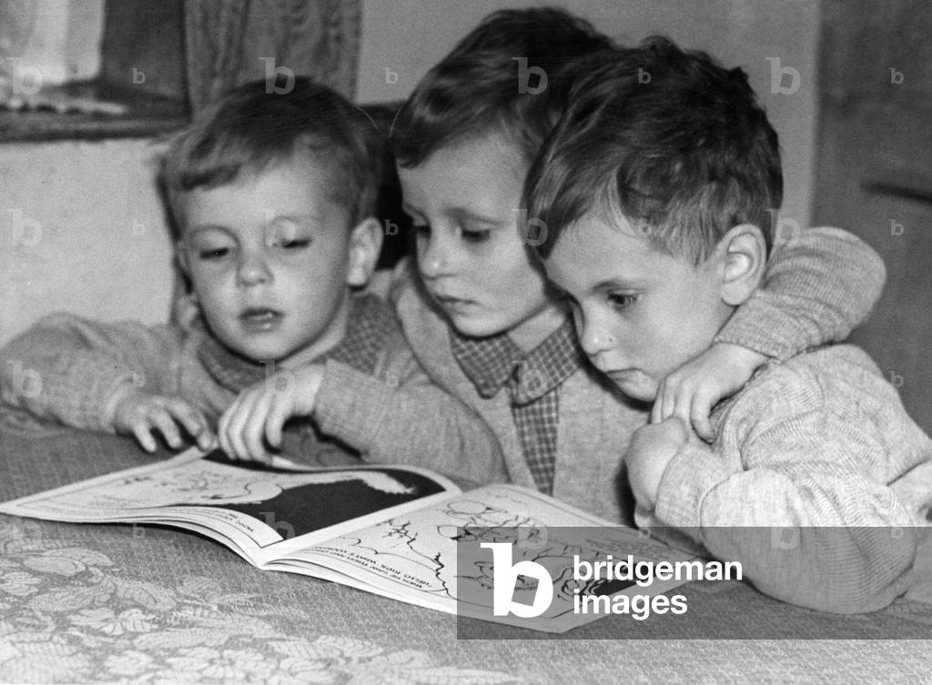 Derek, David & Donald Haden, aged 3 years 6 months, known as the Gornal Wood triplets, the three boys were born on November 24, 1943, to Mary and Wilfred Haden at the Rosemary Ednam Maternity Home, Dudley. Pictured at home, reading, 4th May 1947 (b/w photo)