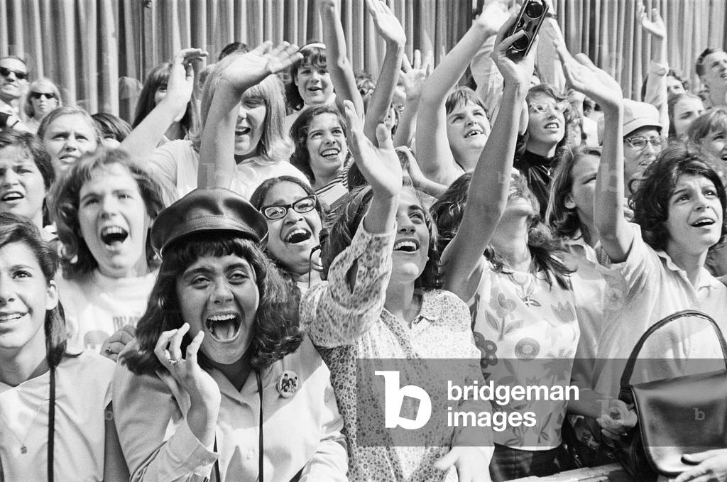 The Beatles in New York City, on their North American Tour ahead of their concert to be held at Forest Hills. Cheering fans gathered outside the Delmonico Hotel in New York where the band are staying. 28th August 1964 (b/w photo)