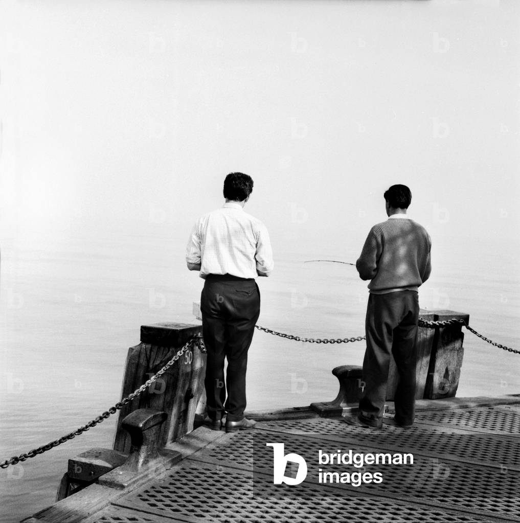Buoy marking sewerage outlet is only few 100 yards from end of Bournemouth pier, and can be seen between fishermen. June 1960