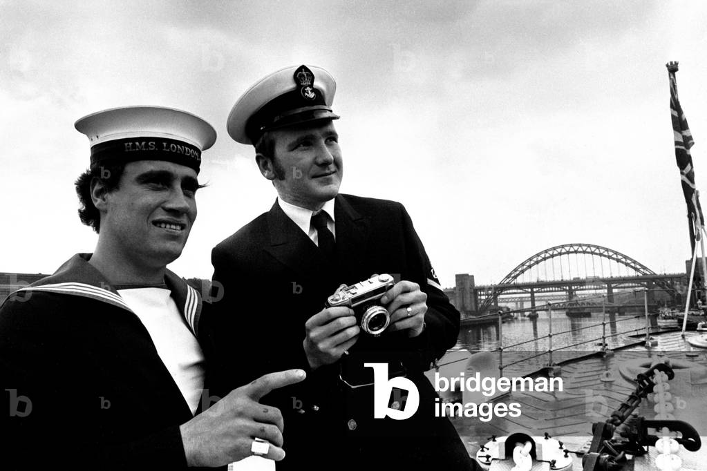 County Class' guided missile destroyer HMS London arrives on the River Tyne for a five day visit to Newcastle. The ship was built by Swan Hunter between 1960-62 and was commisioned the following year. (L to R) AB Ted Gould, of Hartlepool and REA Len Rogers, of Bedlington, both take the chance to snap some Quaysides pictues as the London berthed, 19th May, 1972 (b/w photo)