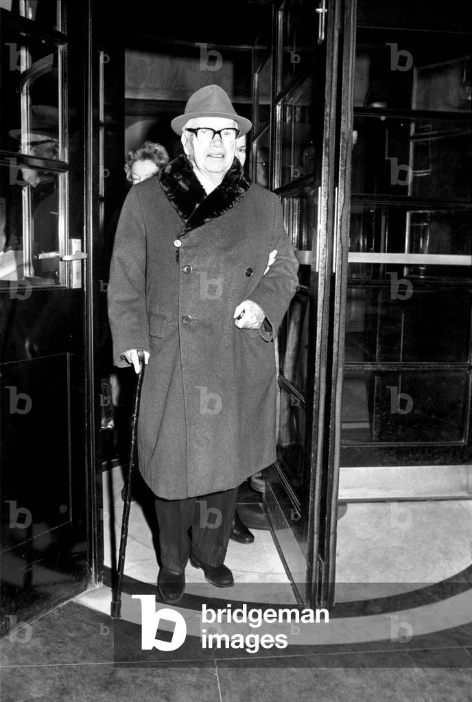 Charlie Chaplin and his wife Oona leave the Savoy Hotel this afternoon to visit friends, 3rd March 1975 (b/w photo)