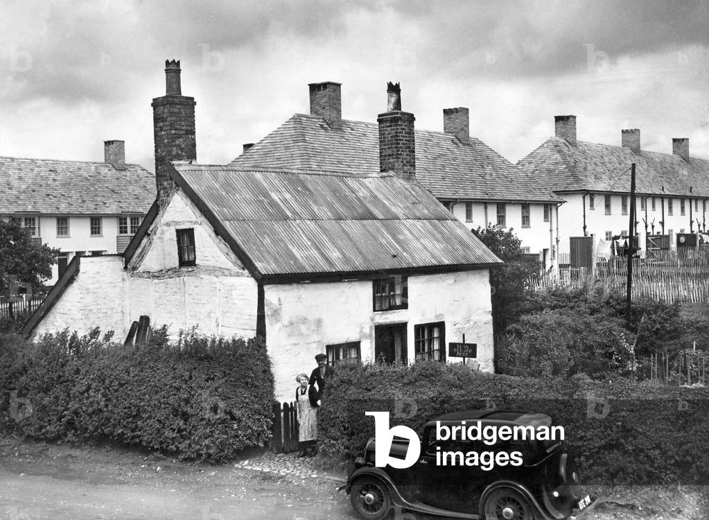 The Old and the New - The 300 year old cottage in Speke town road now surrounded by modern buildings in Speke. 14th June 1938.