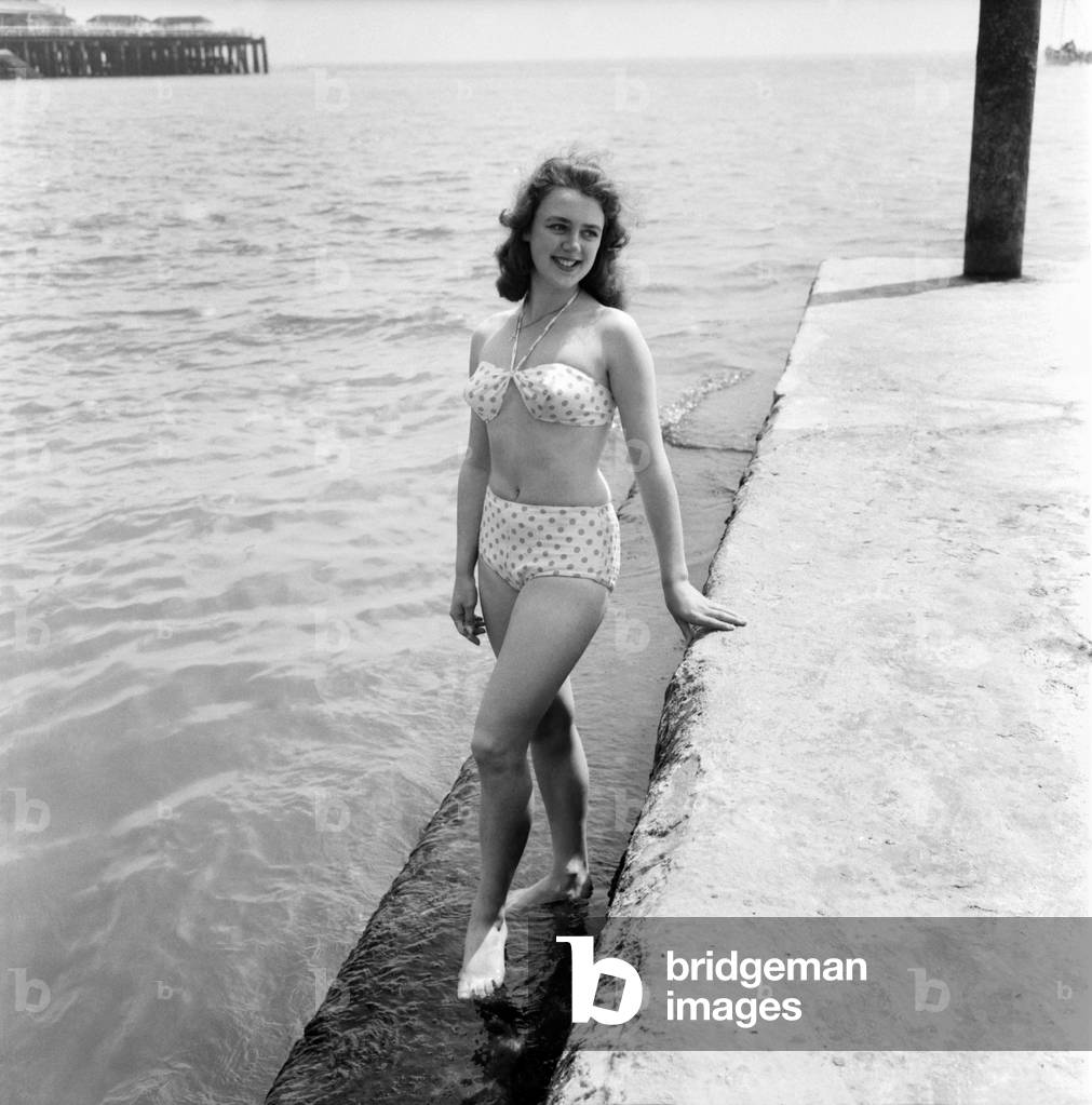 Bathing Girl: Glamour on the Clacton Beach: Pictures of Sherral Mason, 19, a Butlins Red Coat. She comes from Blackpool. June 1960