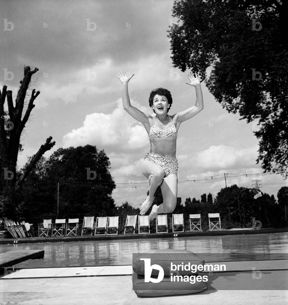 Stage and film actress Betty Paul wearing a bikini by the pool.