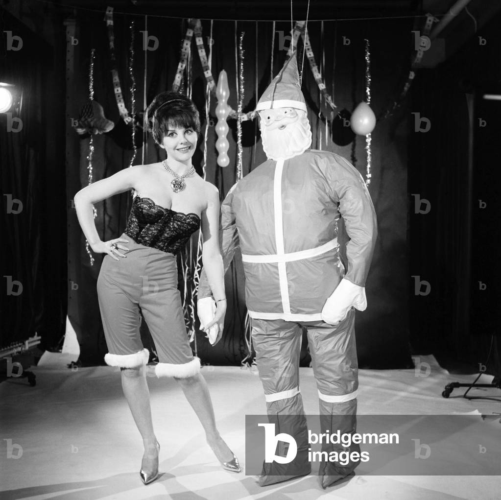 Model Kim Tracy seen here dressed for the office Christmas Party, 1960 (b/w photo)