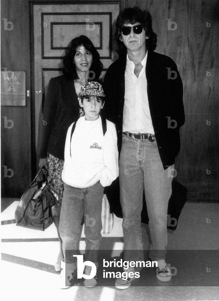 George Harrison formerly of the Beatles with family at London Airport August 1989 (b/w photo)