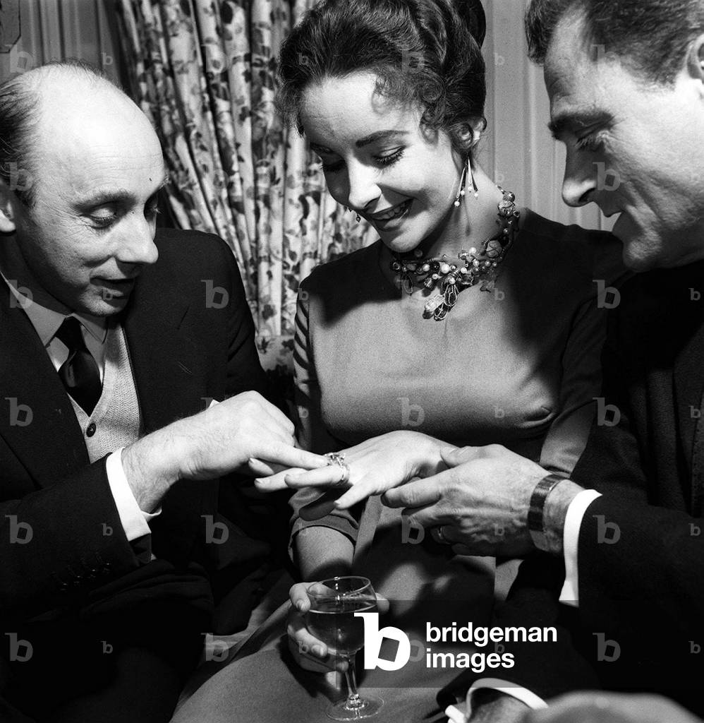 Elizabeth Taylor with Husband Mike Todd showing off diamond ring to Donald Zec, April 1957 (b/w photo)