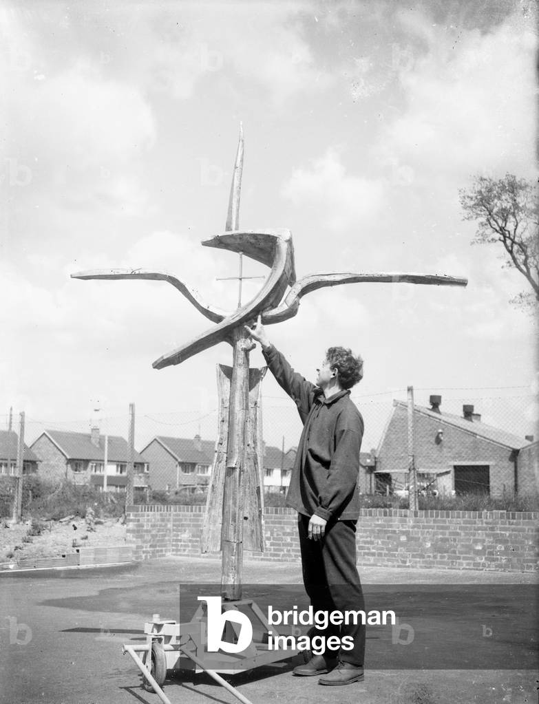 The cross of nails created by Geoffrey Clarke for the high alter at the newly built Coventry Cathedral has a final inspection before being moved to the cathedral circa 1962