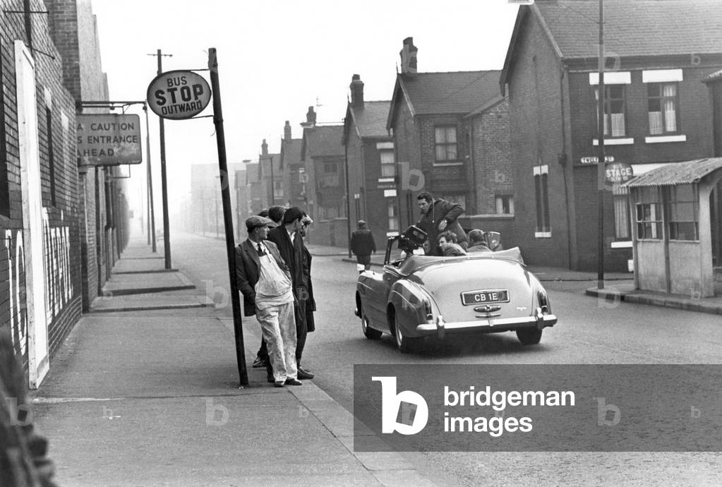 Albert Finney pictured in the bronze Rolls Royce which they used for filming. Some of the local workmen are seen watching, November 1966 (b/w photo)