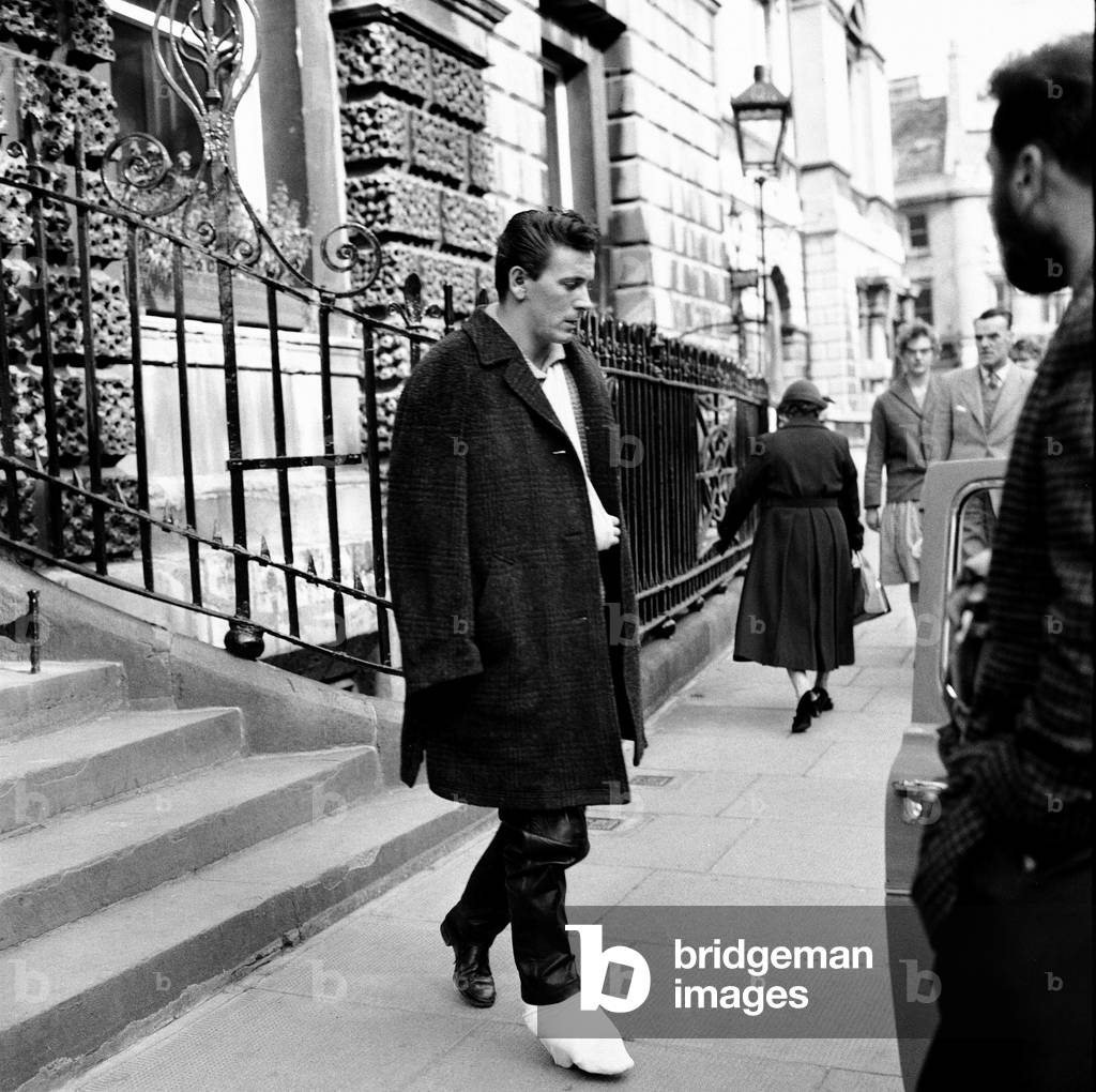 American and roll singer Gene Vincent pictured leaving Bath Hospital after he was injured in a car crash that killed fellow rock n roller friend Eddie Cochran. 22nd April 1960 (b/w photo)
