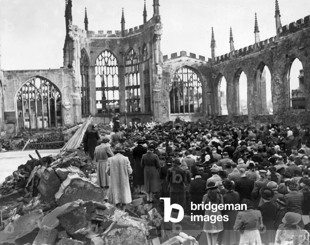 Crowds gather for a remembrance service inside the ruins of Coventry Cathedral after it was destroyed by the German Luftwaffe in air raid over the city during the Second World War, 15th November 1942