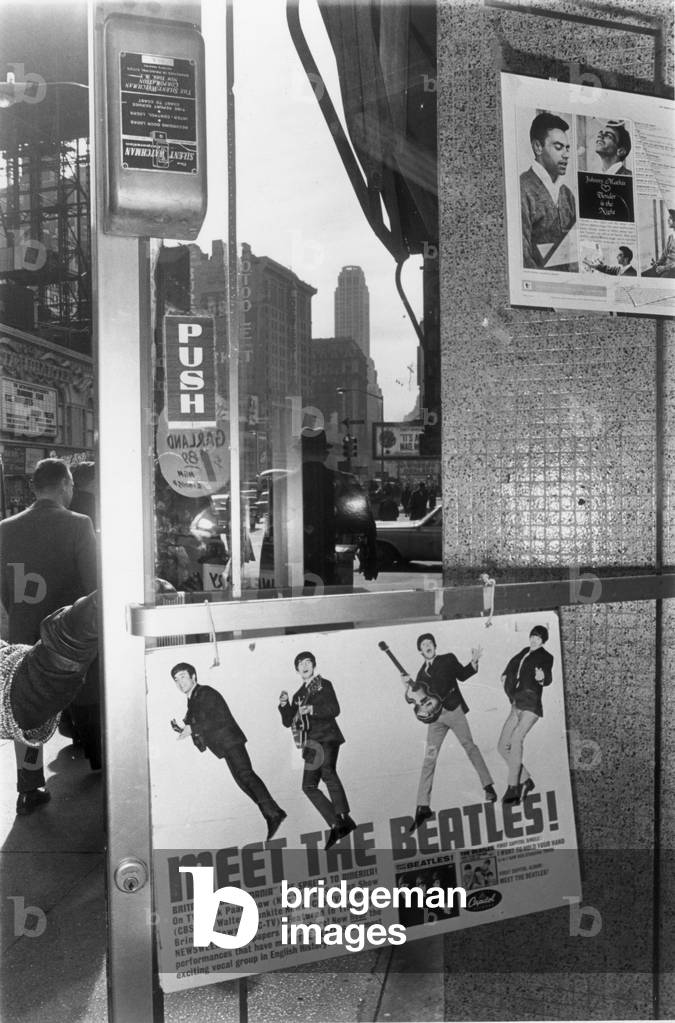Beatles poster in shop window of Grimbles Store on 33rd Street in New York USA 5th February 1964.
