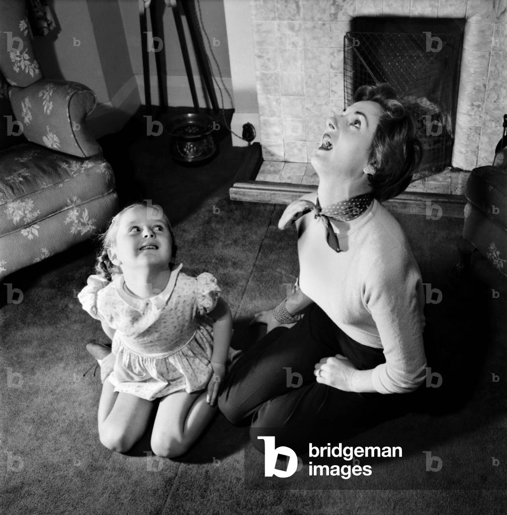 Woman and girl exercising Muriel Cordett and daughter Caroline (5) Muriel is to model spring fashions before Queen mother and Princes Margaret. November 1953