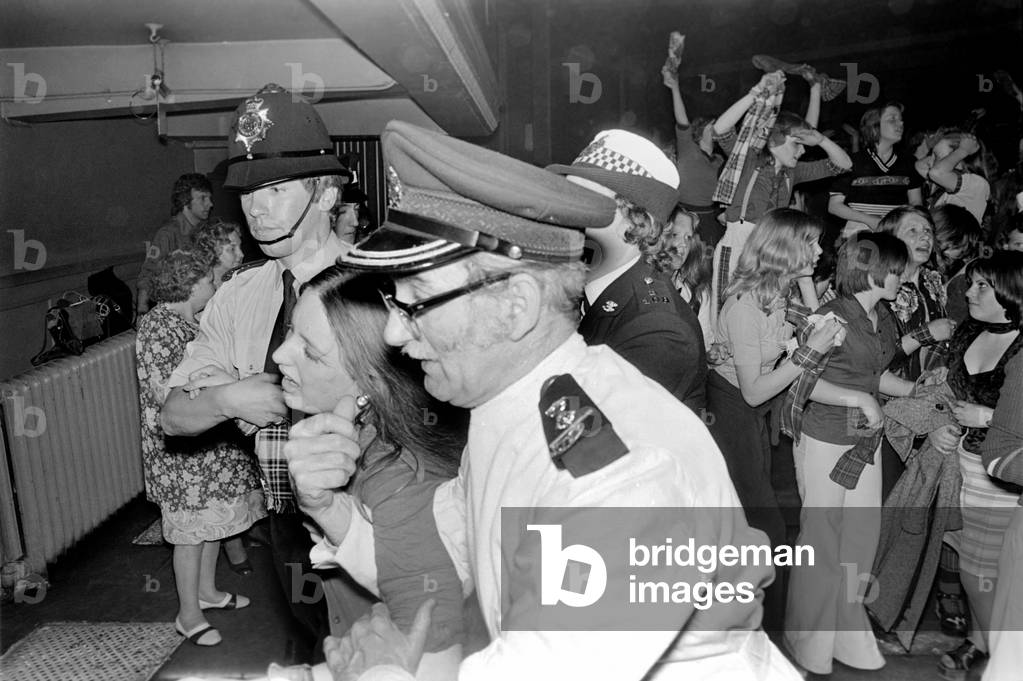 Medical officers attend to injured fans of the Bay City Rollers at their gig in Cardiff, May 1975 (b/w photo)