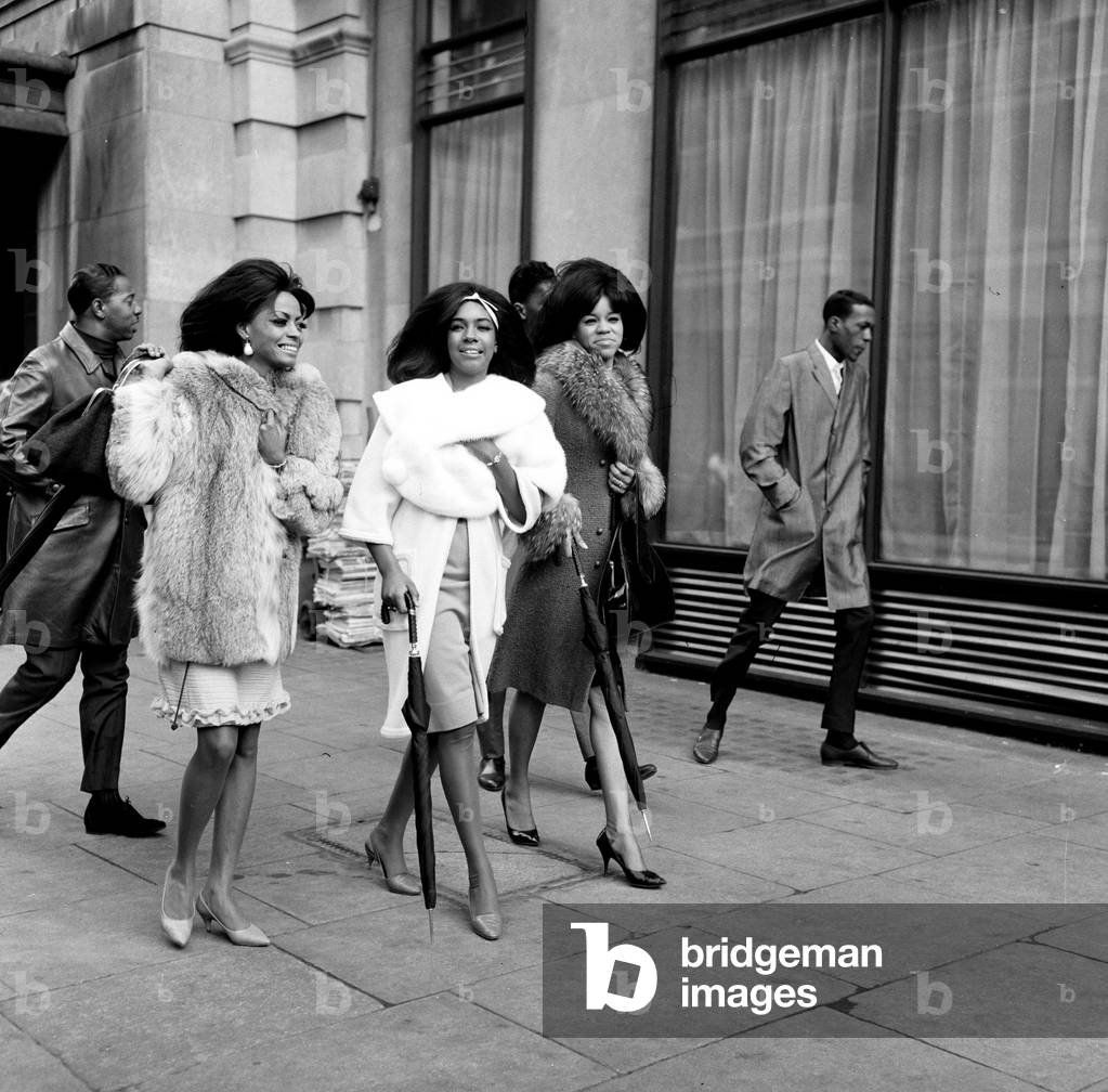 The Supremes walking in Great Cumberland Street, London holding umbrellas 15th March 1965 (b/w photo)