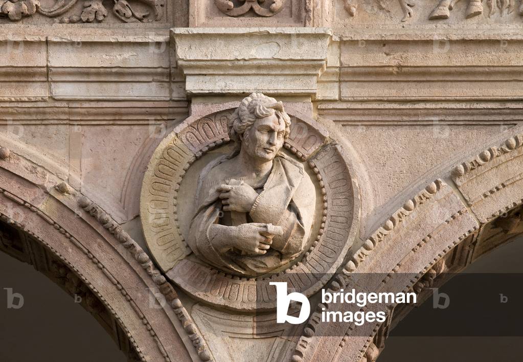 Male figure, priest, by Giovanni Antonio Amadeo, Cloister of Ospedale Maggiore, Universita degli Studi, Milan, Lombardy, Italy (photo)