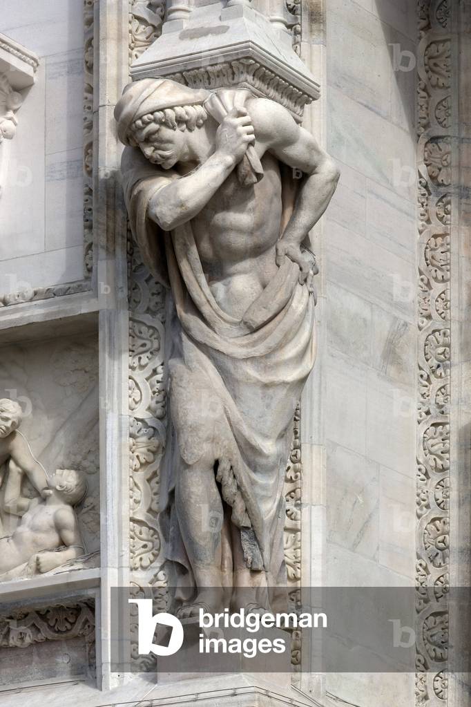Architecture: view of an Atlantean or (telamon), about 1650. Detail of the facade of the Cathedral (dome or duomo) of Milan Italy