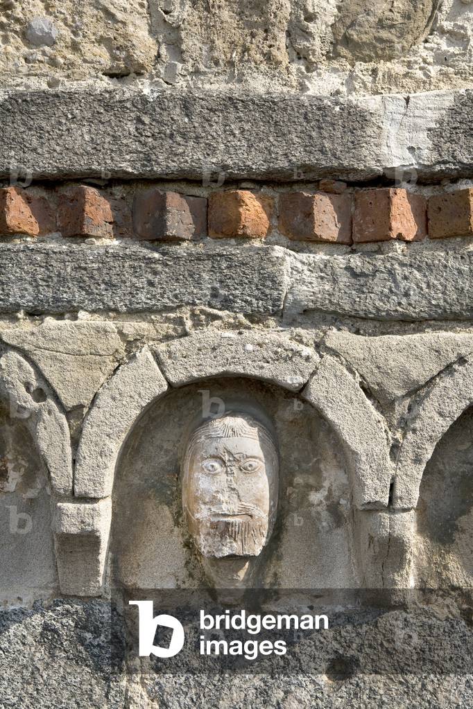 Detail of the facade, protome with male face by Wiligelmo School, Church of Santo Stefano, Vimercate, Monza Brianza, Lombardy, Italy (photo)