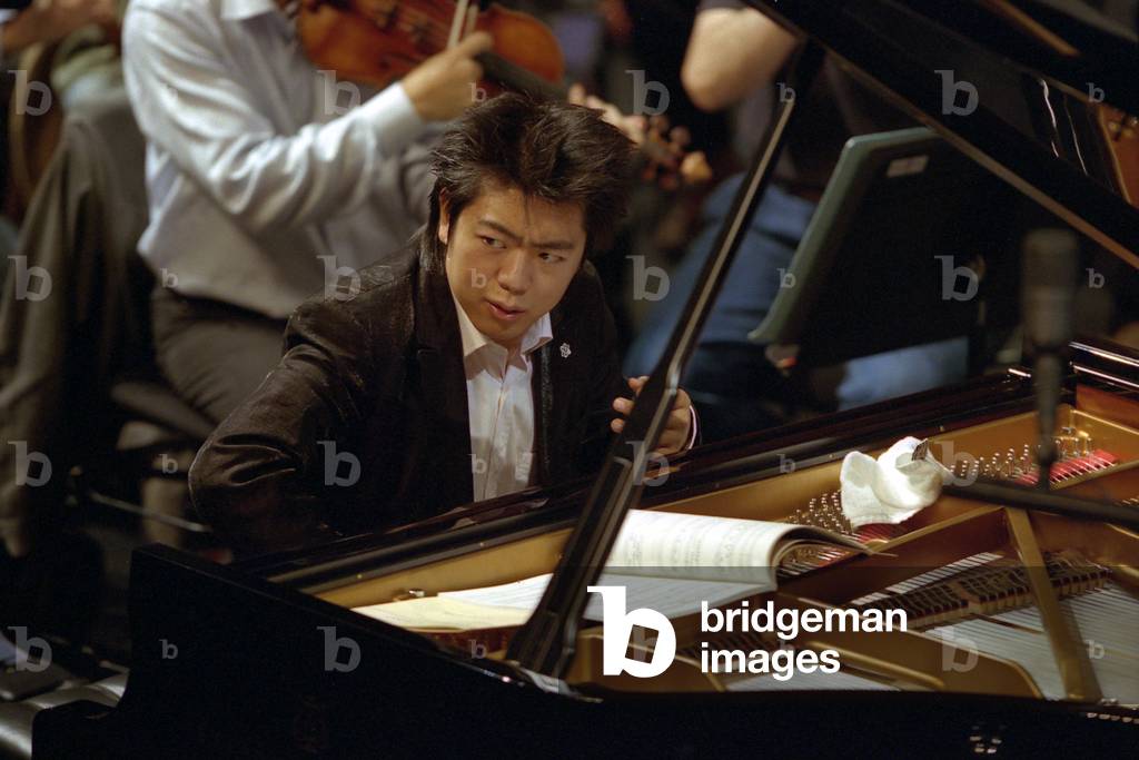Lang Lang - rehearsing with the Orchestre de Paris, Paris, October 2005. Chinese Pianist: Born 14 June 1982.