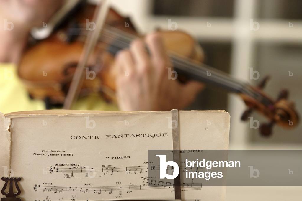 Score by André Caplet with a violin being played in background. Andre Caplet, French composer, 23 November 1878  22 April 1925.
