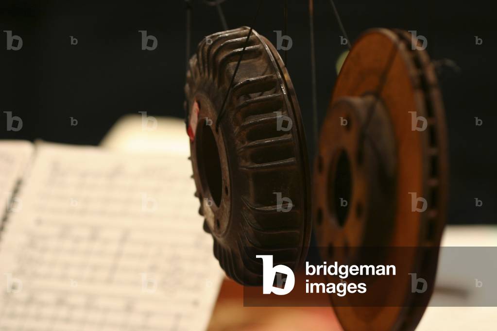 Percussion instuments - car breaks hanging next to a score for a Helmut Lachenmann work at the Cité de la Musique, Paris, France, May 2006.