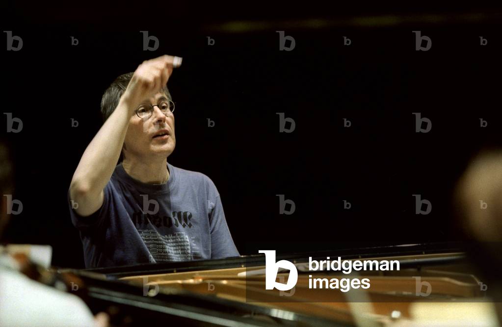 Christian Zacharias performing in 2001. Condcuting from the piano keyboard.   German conductor and pianist,