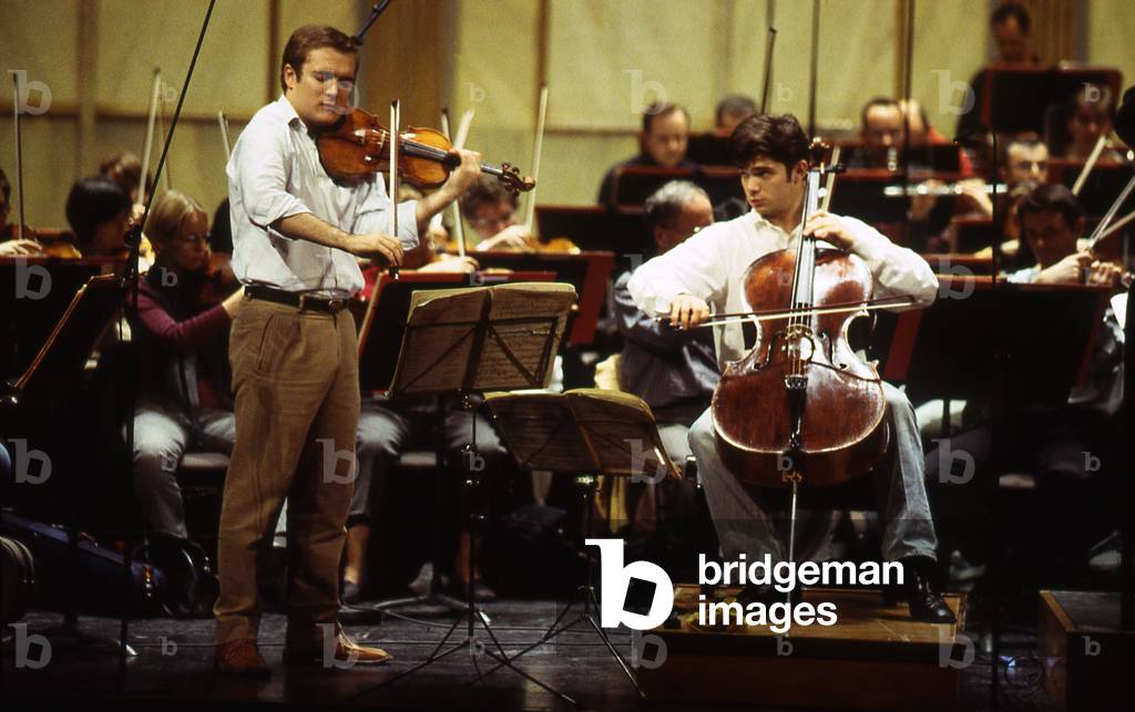 Renaud and Gautier Capuçon rehearsing with l'Orchestre de Paris, Salle Pleyel, 2002. Renaud Capuçon, French violinist, b. 27 January, 1976 -. Gautier Capuçon, French cellist, b. 3 September, 1981 -.