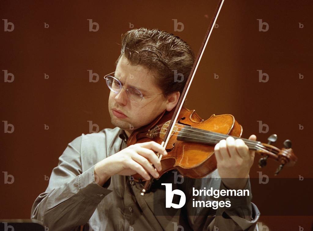 Julian Rachlin playing the violin with the National Orchestra of France, March 2006. Lithuanian born Austrian violinist. b. 1974