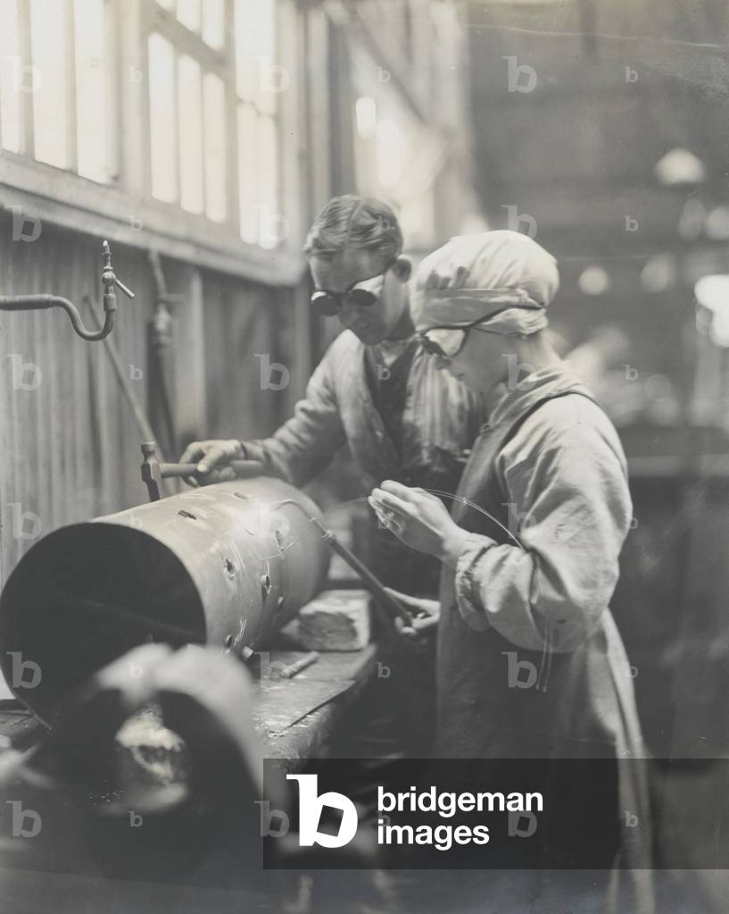 Photograph of a Women’s Army Auxiliary Corps mechanic in a Royal Flying Corps workshop, 1917 (b/w photo)