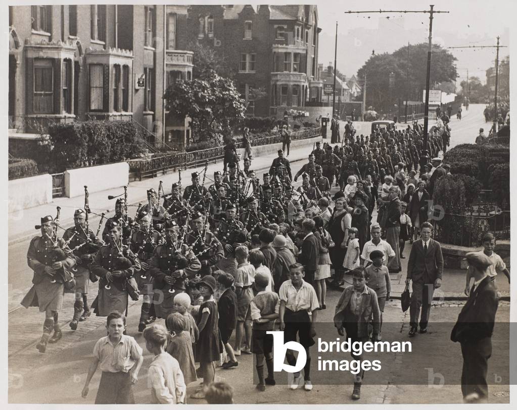 1st Bn Highland Light Infantry marching down Military Hill, Dover, on the first stage of its 100 mile ‘economy’ march to Arundel, Sussex (b/w photo)