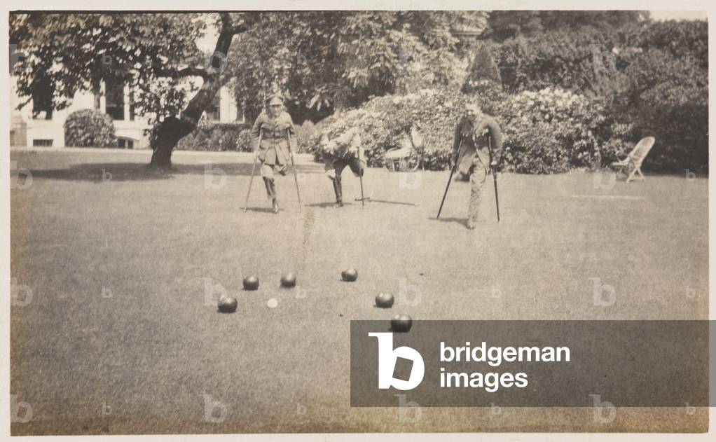 Amputees playing bowls during convalescence in the gardens of Dover House in 1918 (b/w photo)