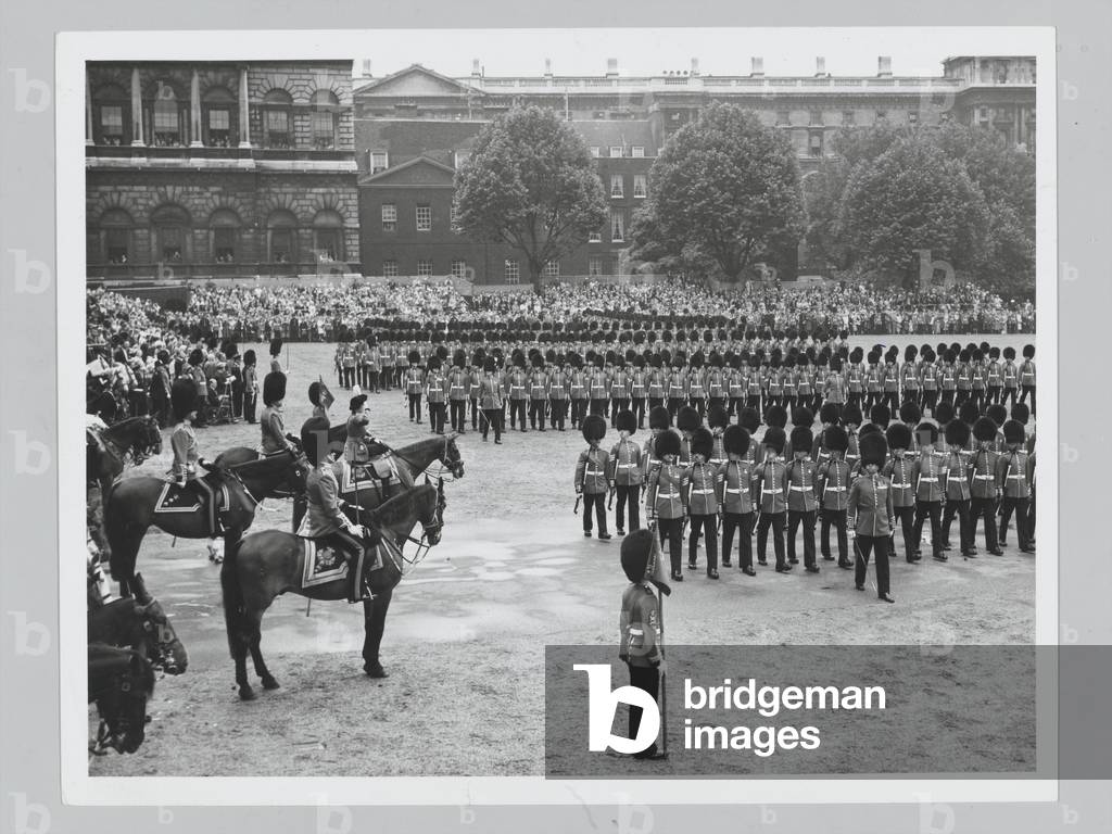 H.M. The Queen, in the scarlet of the Grenadiers and wearing a black tricorn hat with a white plume took the salute at the Trooping of the Colour Ceremony, the Queen’s Official Birthday, on Horse Guards Parade, 11 June 1960 (b/w photo)