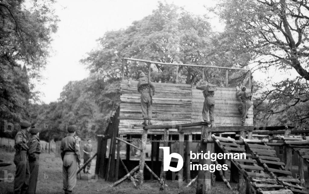 Recruits on the assault course, Commando Basic Training Centre, Achnacarry, Inverness-shire, c.1942 (b/w photo)