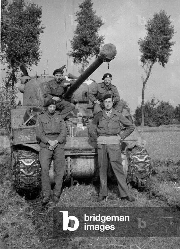 Members of B Squadron, 3rd/4th County of London Yeomanry (Sharpshooters) pose next to Sherman Firefly tank (b/w photo)