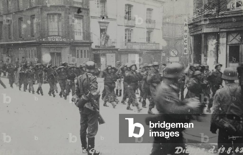 One of 6 photographs showing captured British prisoners, some of whom are wounded, marching through Dieppe, France, 1942 (b/w photo)
