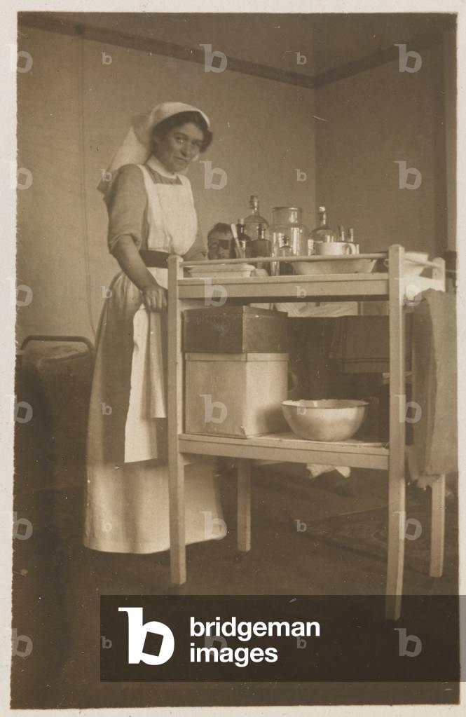 A nursing sister changing the dressing on Second Lieutenant Cyril Edwards wounded leg at Endsleigh Palace Hospital, September 1917 (b/w photo)